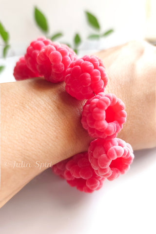 Close-up of polymer clay raspberry bracelet worn on a wrist, showing velvety texture detail — Julia Spiri